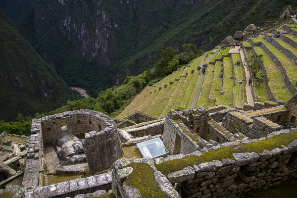 A view of the sun temple from above. Apparently the sun temple was dedicated to the solar god and patron Incan deity, Inti. The temple was an important observatory in which the measurement of the solstices was undertaken. Underneath the Sun Temple is a cave-like room named the Royal Tomb in which the nobles and possible the Sapa Inca, ruler of the Cusco Empire and later the Inca Empire, were laid to rest in their mummified state.