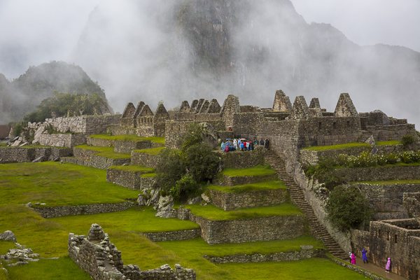 Visitors explore the "urban" or residential areas of Machu Pichu which are built in the lower regions of the city and housed farmers, servants and teachers etc. 