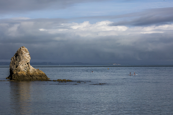 Early morning paddle boarders explore Tasman Bay--best described in shades of blue--in the sweet coastal town of Nelson.