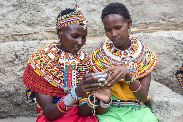 A couple of the younger women show share their work with each other after taking their first few photos.