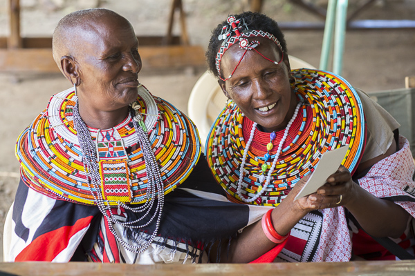 Elder workshop attendees, Joice Lampate and Maria Letiwe, look at one of their prints from the workshop.
